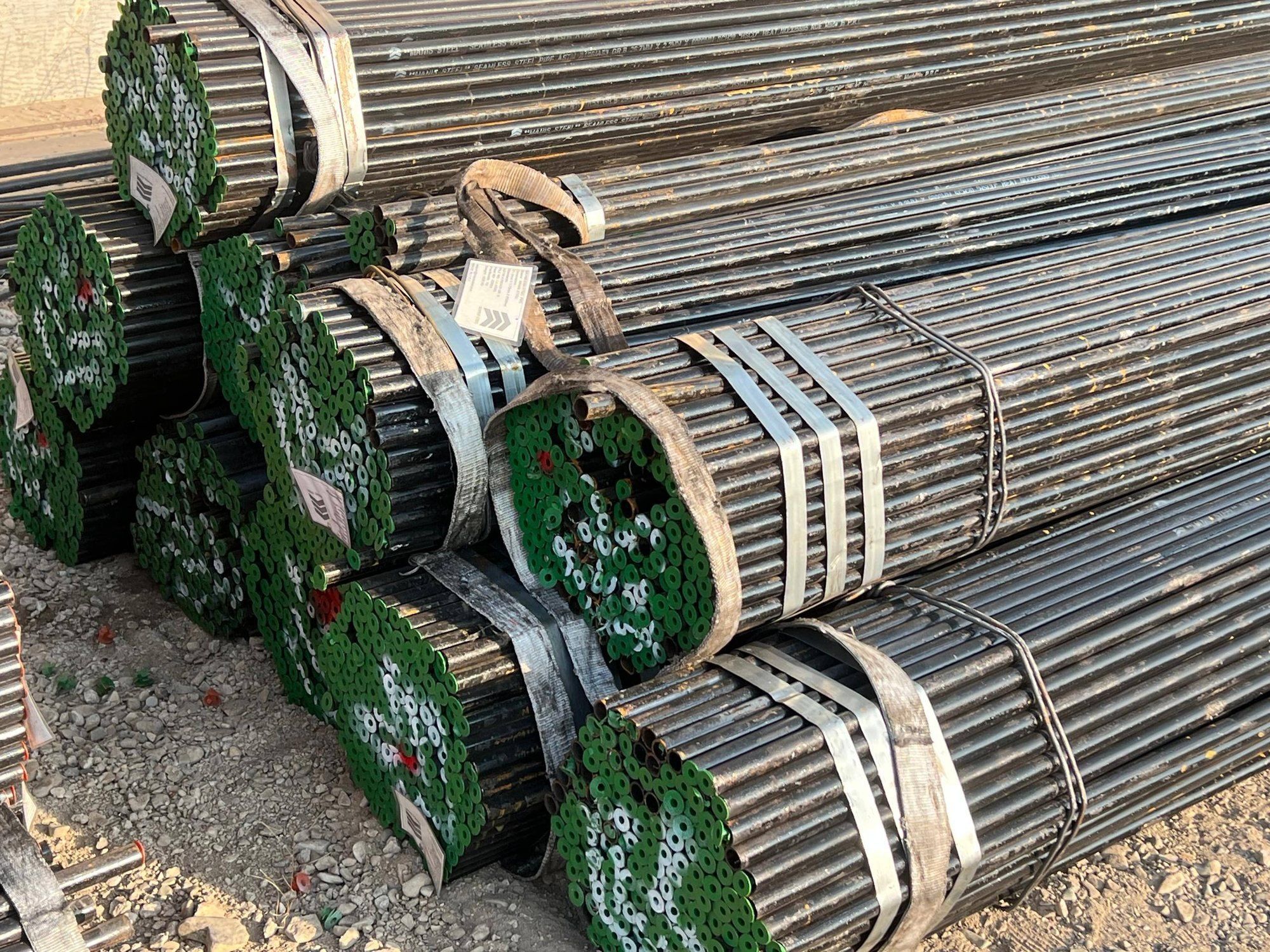 Strapped bundles of black seamless pipe in our sister brand’s yard