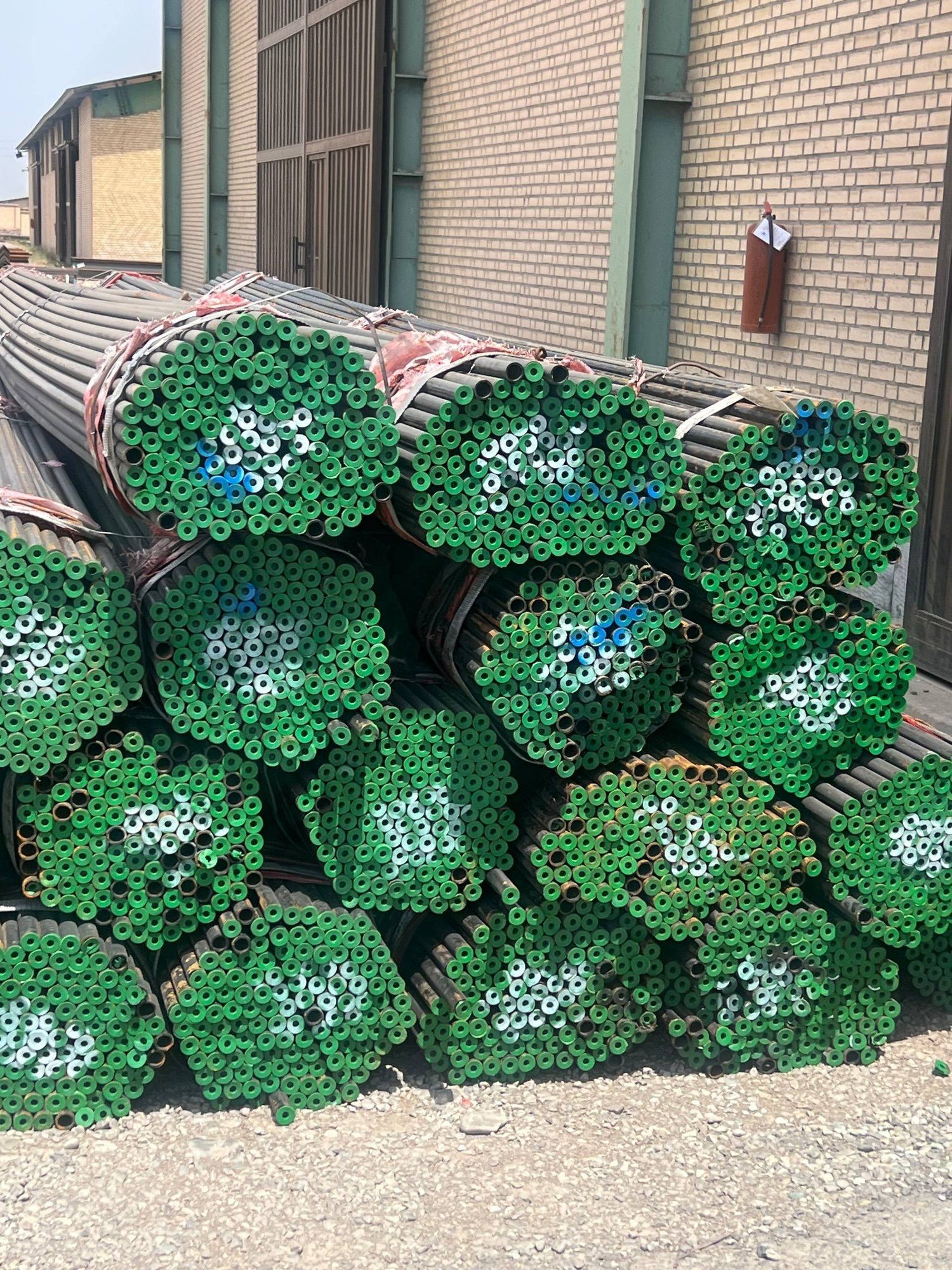 Pipe bundles with green end caps in our sister brand’s yard in Tehran